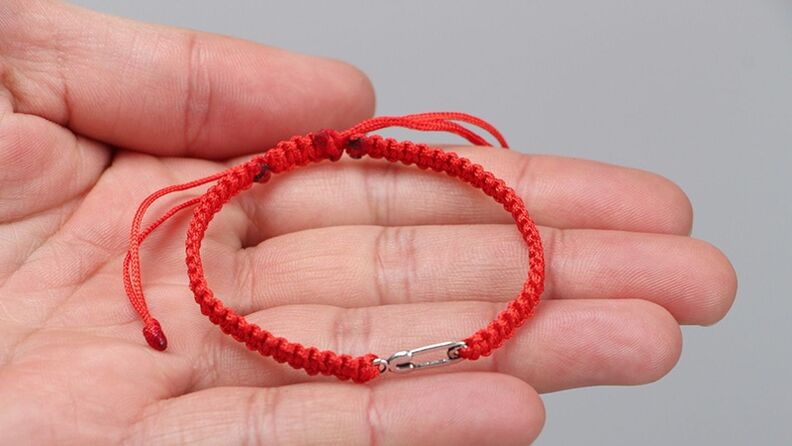 Amulet with red thread that attracts good luck