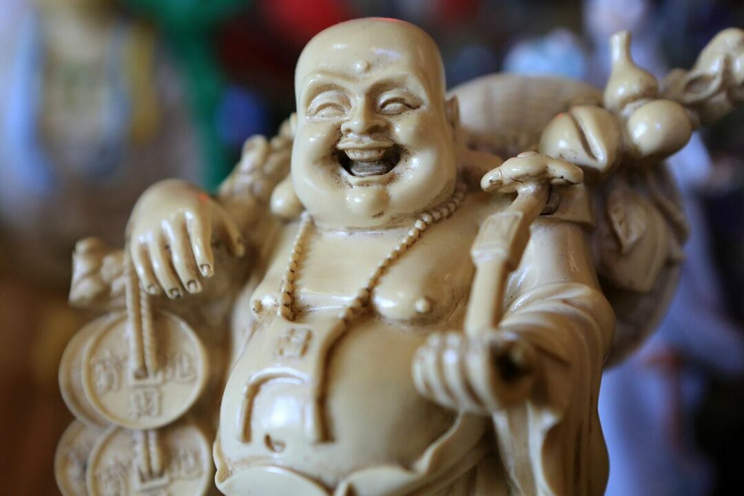 an amulet of health and family well-being - a smiling Buddha