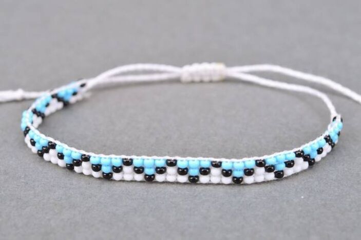 A bracelet made of thread and pearls is a talisman that will bring happiness to the owner